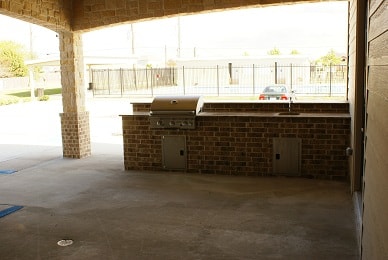 Covered outdoor patio with built-in brick grill station