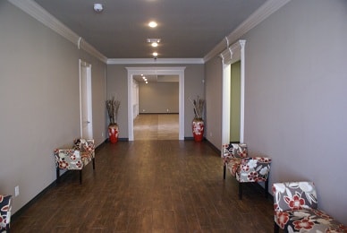 Foyer hallway with hardwood floors and decorative seating